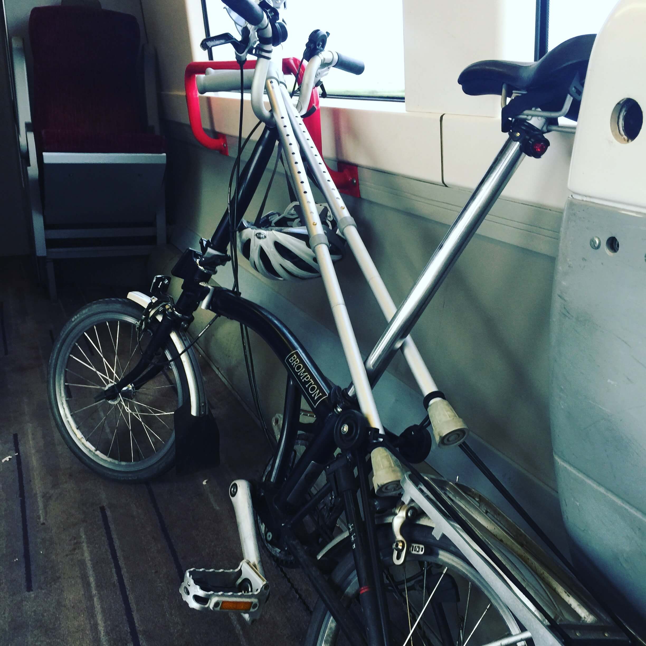 A Brompton bike and crutches on a train